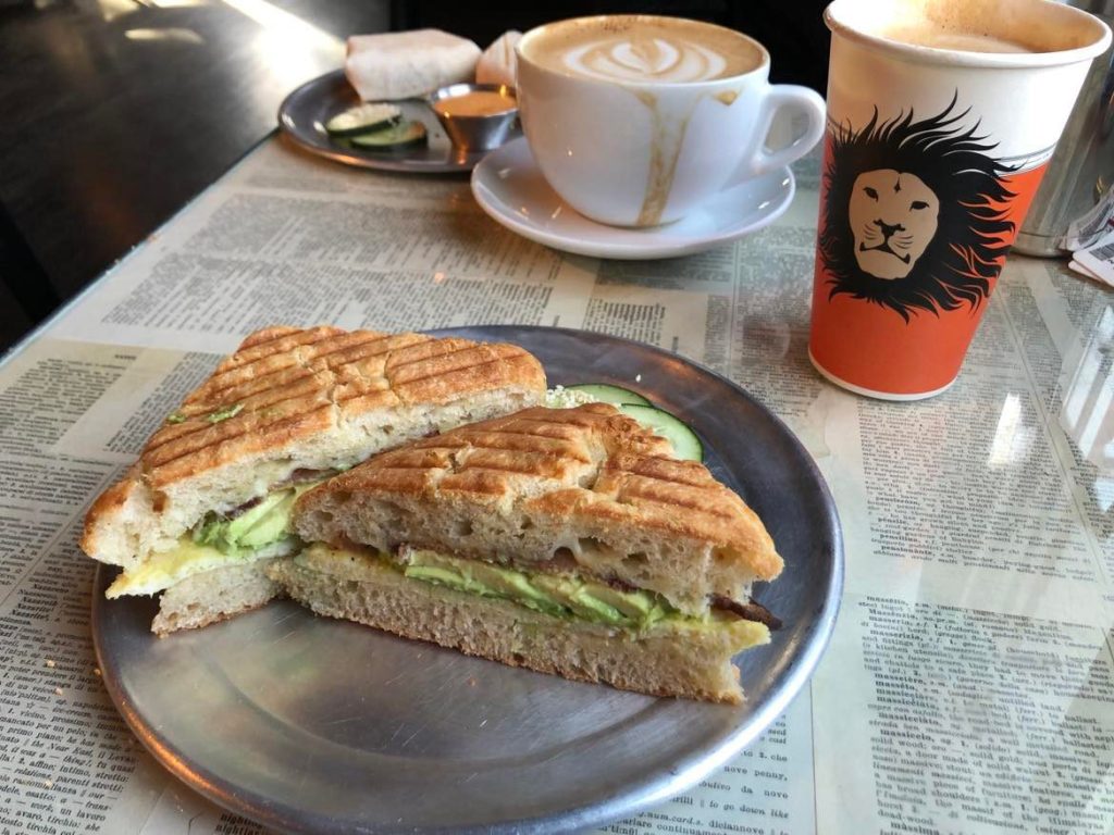 Breakfast sandwich and coffee on a table at Coffeebar Reno