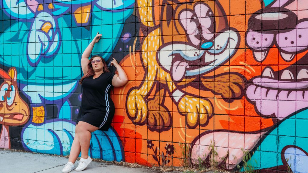 gabbi poses with a mural in Midtown Reno, Nevada