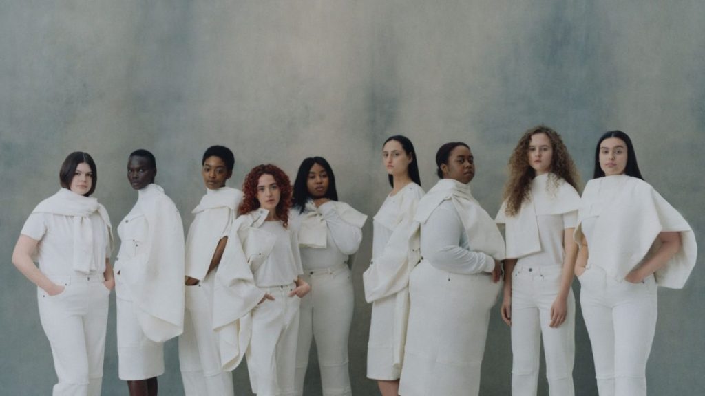 9 universal standard models stand in all white outfits